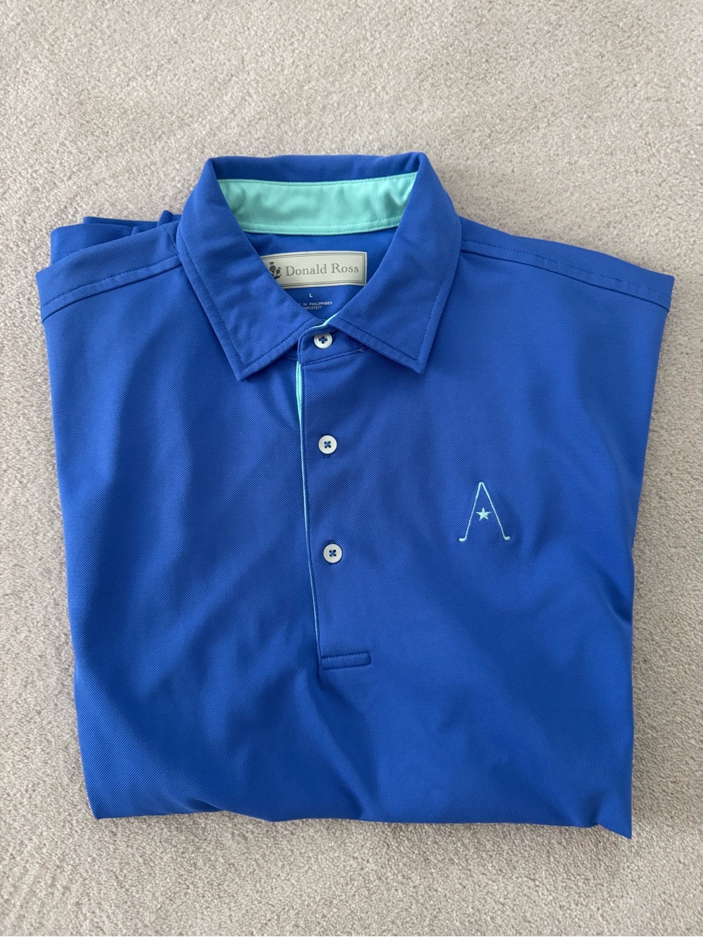 Donald Ross Blue Polo with Green trim.